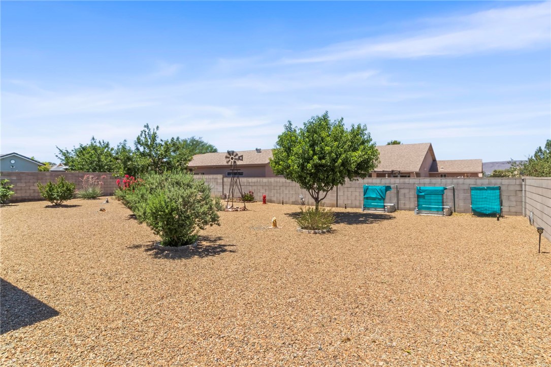3897 Easy Street Kingman, AZ 86409 - Photo 40 of 53 a view of a house with a yard and potted plants
