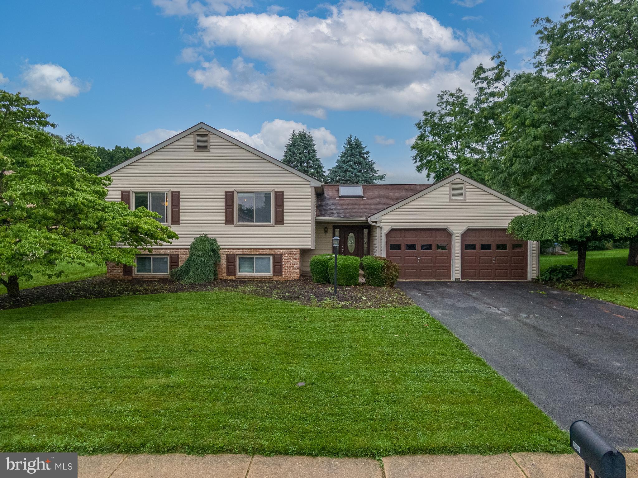 4903 Farming Ridge Boulevard Reading, PA 19606 - Photo 1 of 33 a front view of a house with garden