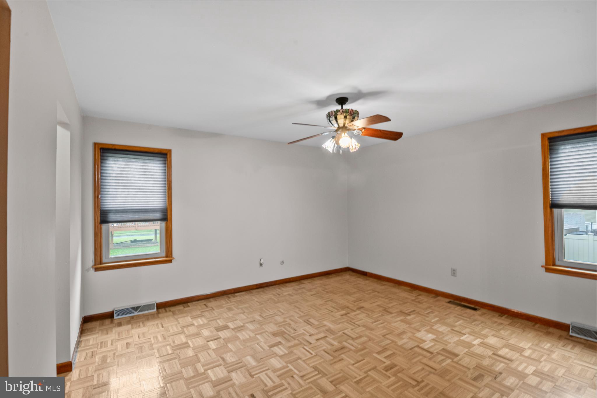 4903 Farming Ridge Boulevard Reading, PA 19606 - Photo 14 of 33 an empty room with windows and chandelier fan