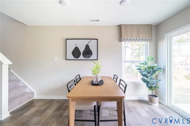 a view of a dining room with furniture window and wooden floor