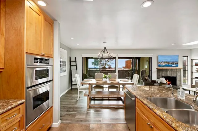 a kitchen with stainless steel appliances granite countertop a sink counter space cabinets and a stove