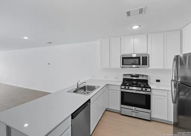 a kitchen with a sink a stove and refrigerator