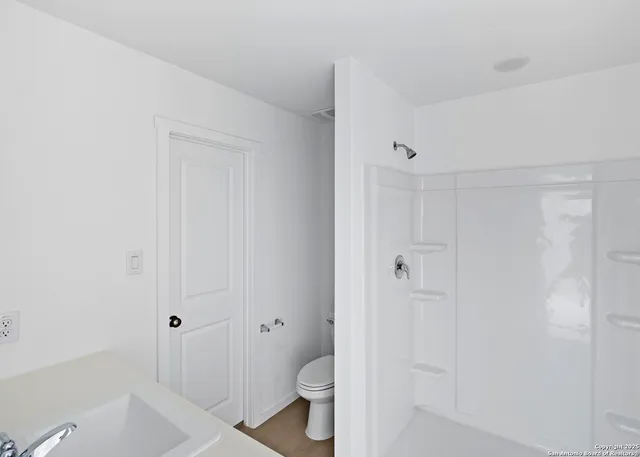 a bed room with a bed and a painting on the wall