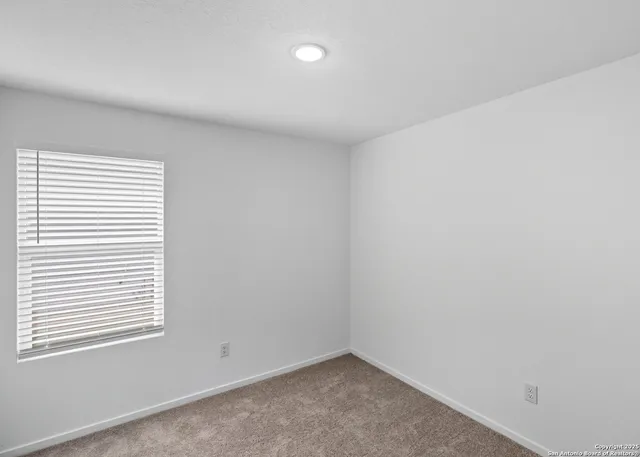 a bedroom with a bed and a potted plant