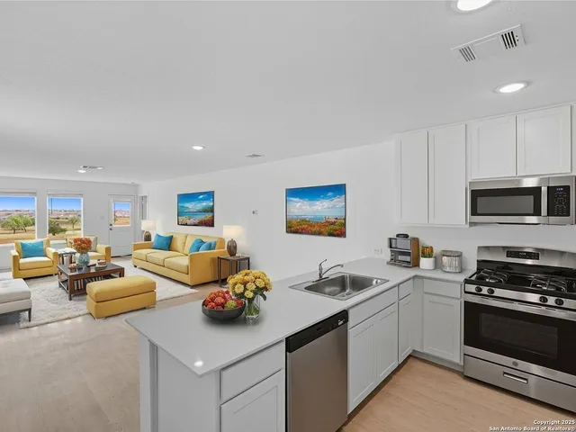 a kitchen with granite countertop a sink and a stove top oven