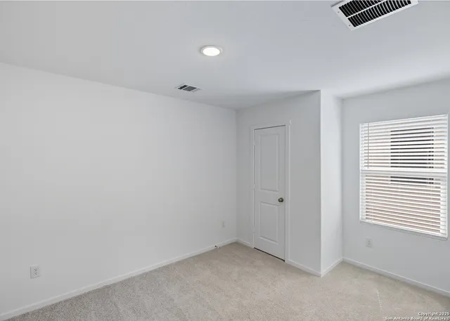 a bathroom with a sink mirror and toilet