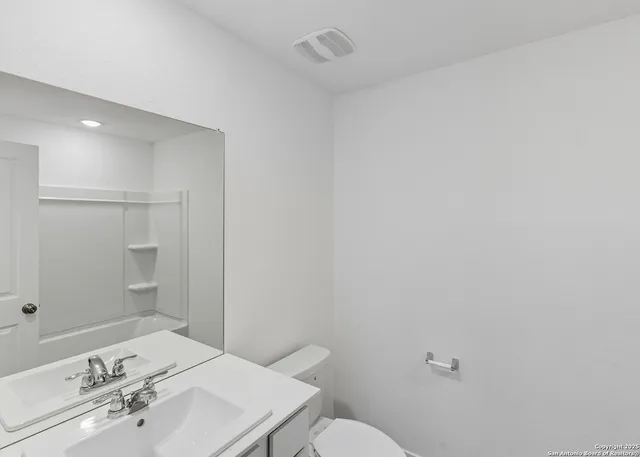 a bedroom with a bed and painting on the wall