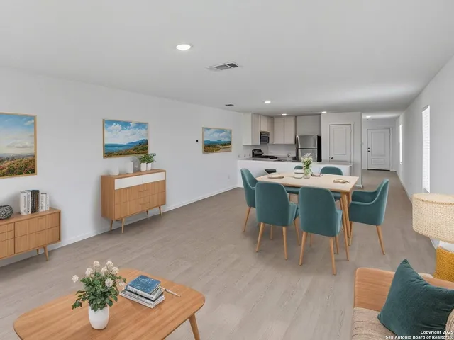 a living room with stainless steel appliances kitchen island granite countertop furniture and a dining table