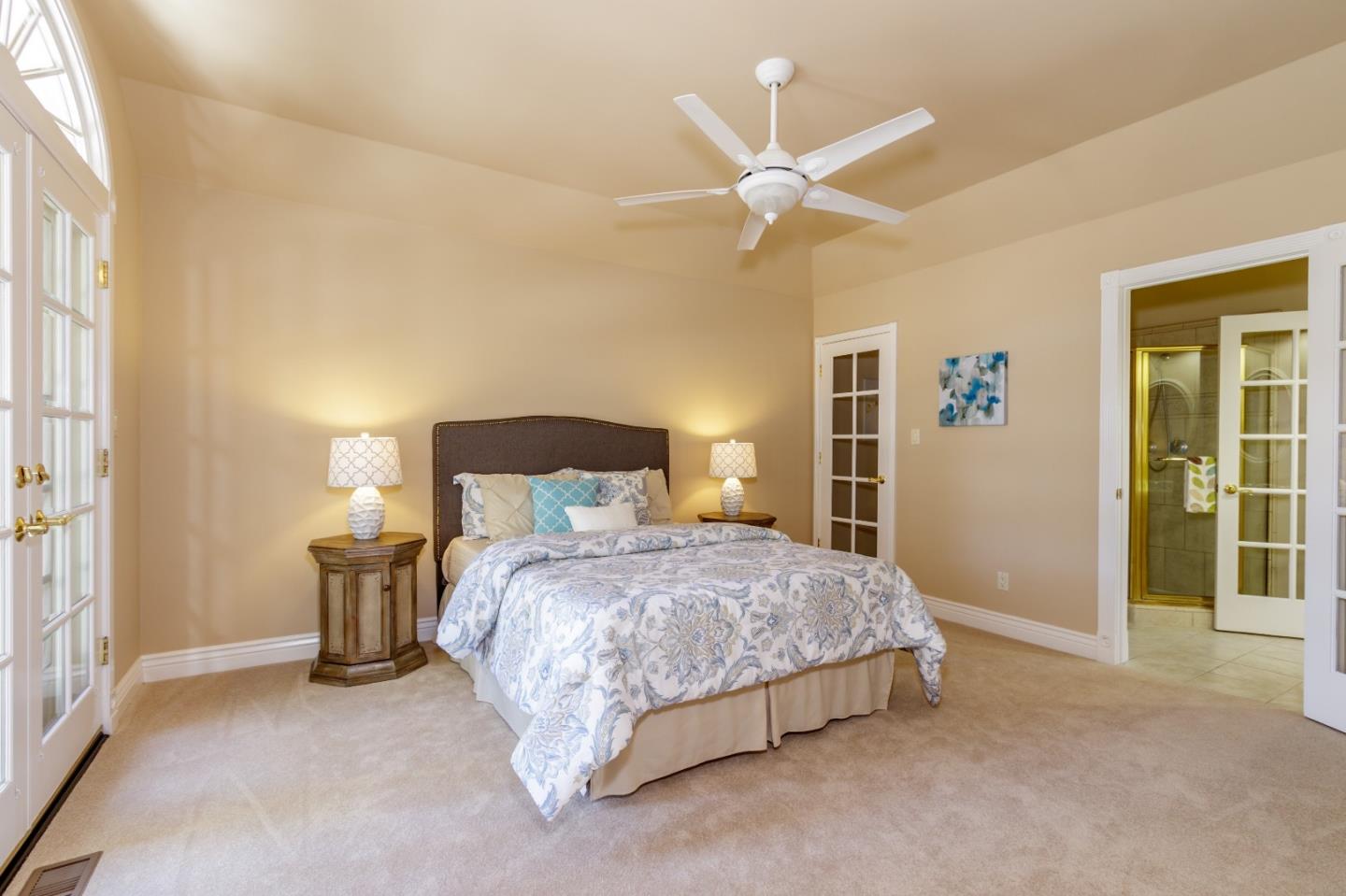 20585 Scofield Drive Cupertino, CA 95014 - Photo 24 of 32 a bedroom with a bed and a chandelier
