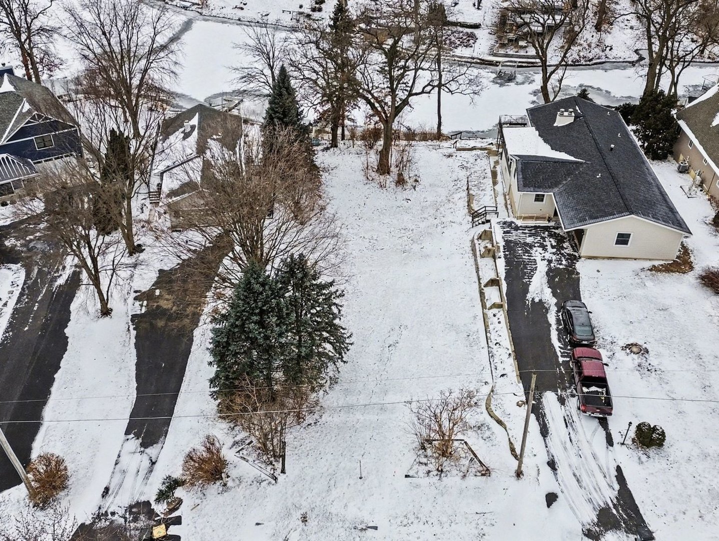 a view of a yard with wooden fence