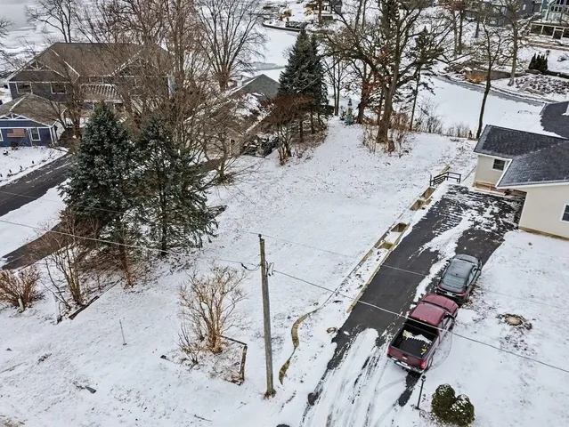 a view of a yard with snow on the road