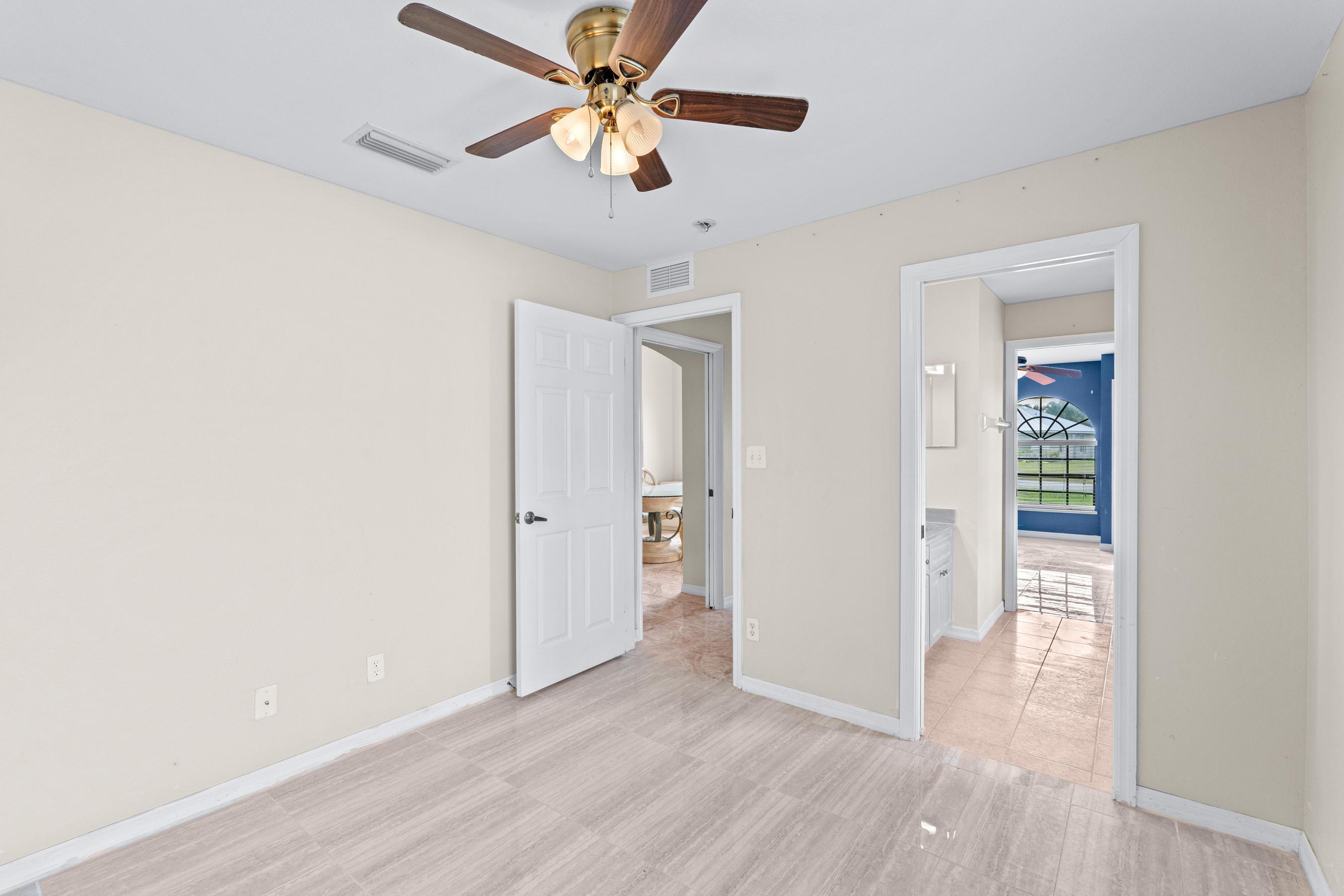 907 Sawgrass Street Clewiston, FL 33440 - Photo 34 of 60 wooden floor in an empty room with a window