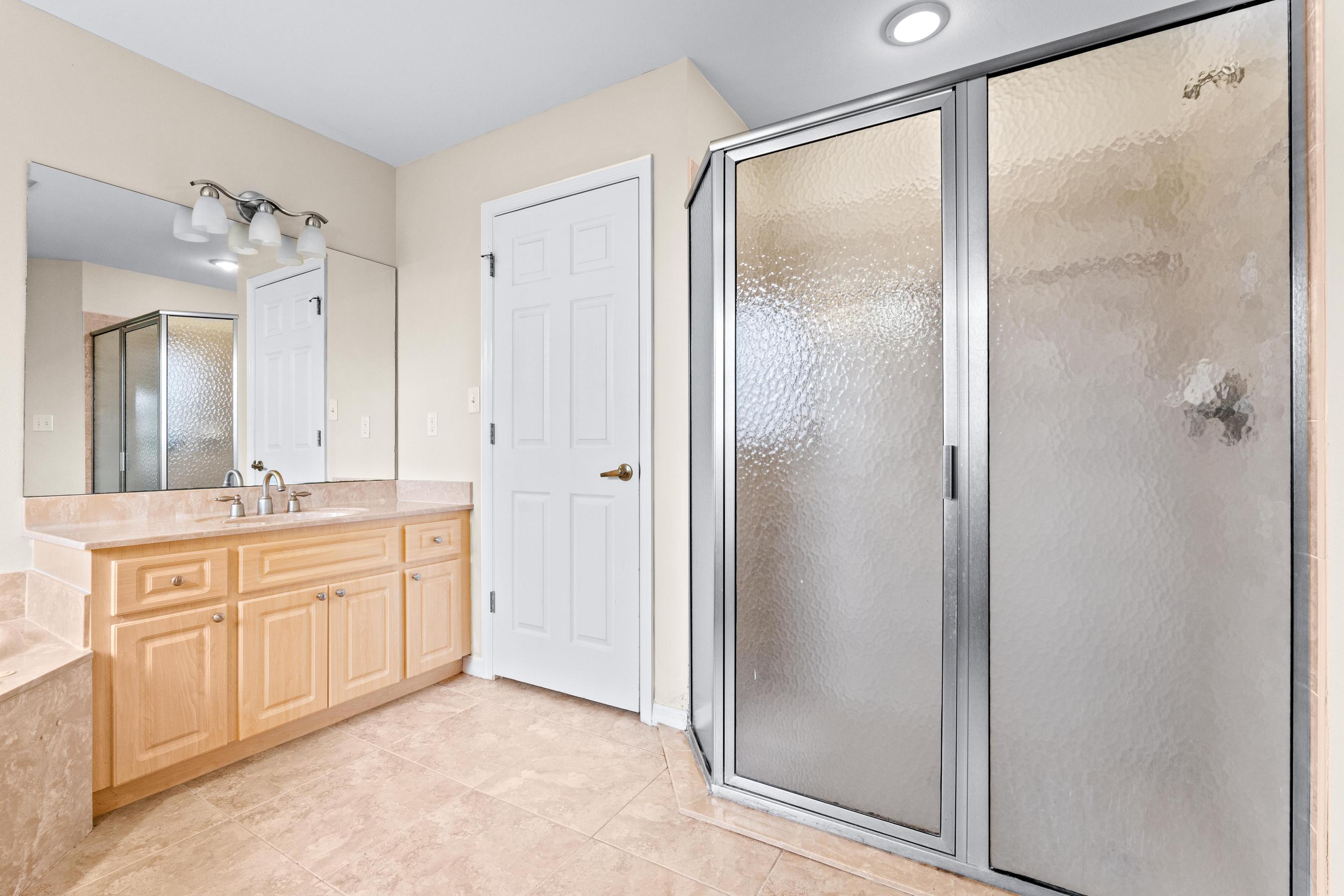 907 Sawgrass Street Clewiston, FL 33440 - Photo 52 of 60 a bathroom with a granite countertop sink mirror and a