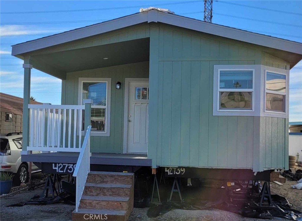 a backyard of a house with barbeque oven table and chairs