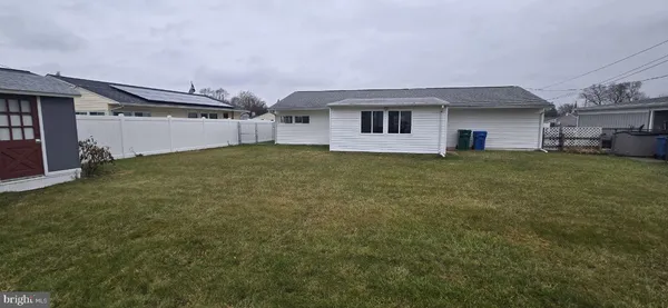 a view of a house with a backyard