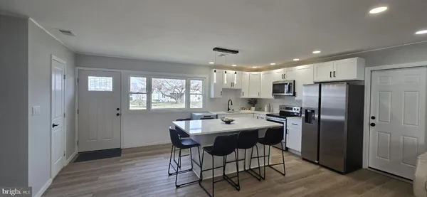 a kitchen with a table and chairs in it