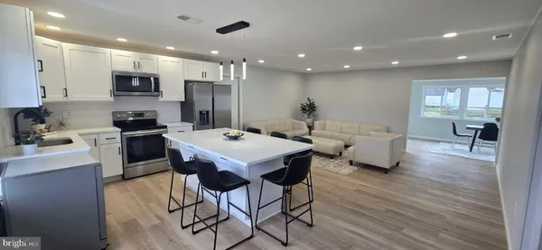 a large kitchen with a table and chairs
