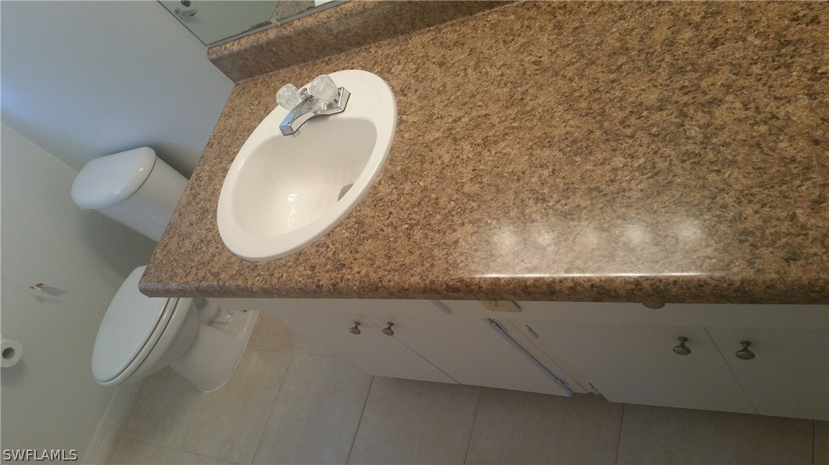 207 Jasmine Road West Lehigh Acres, FL 33936 - Photo 20 of 25 a bathroom with a sink and a mirror
