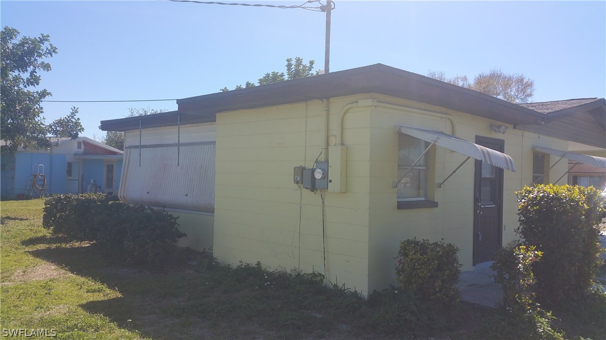 207 Jasmine Road West Lehigh Acres, FL 33936 - Photo 3 of 25 a view of a house with a backyard