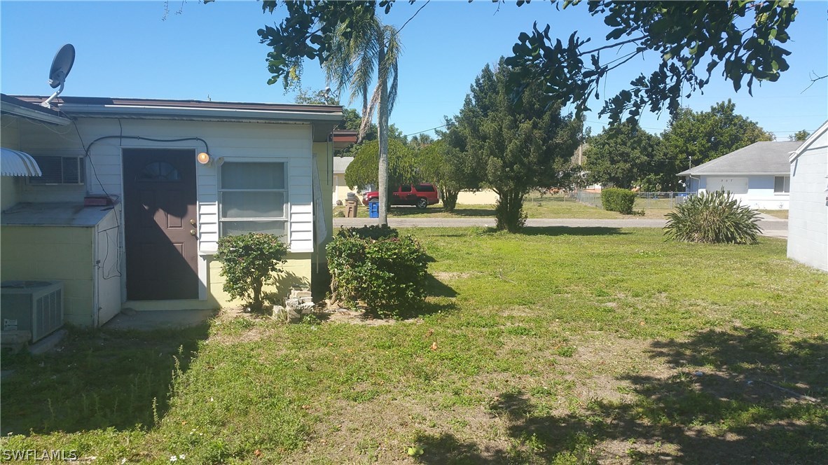207 Jasmine Road West Lehigh Acres, FL 33936 - Photo 4 of 25 a view of a house with backyard