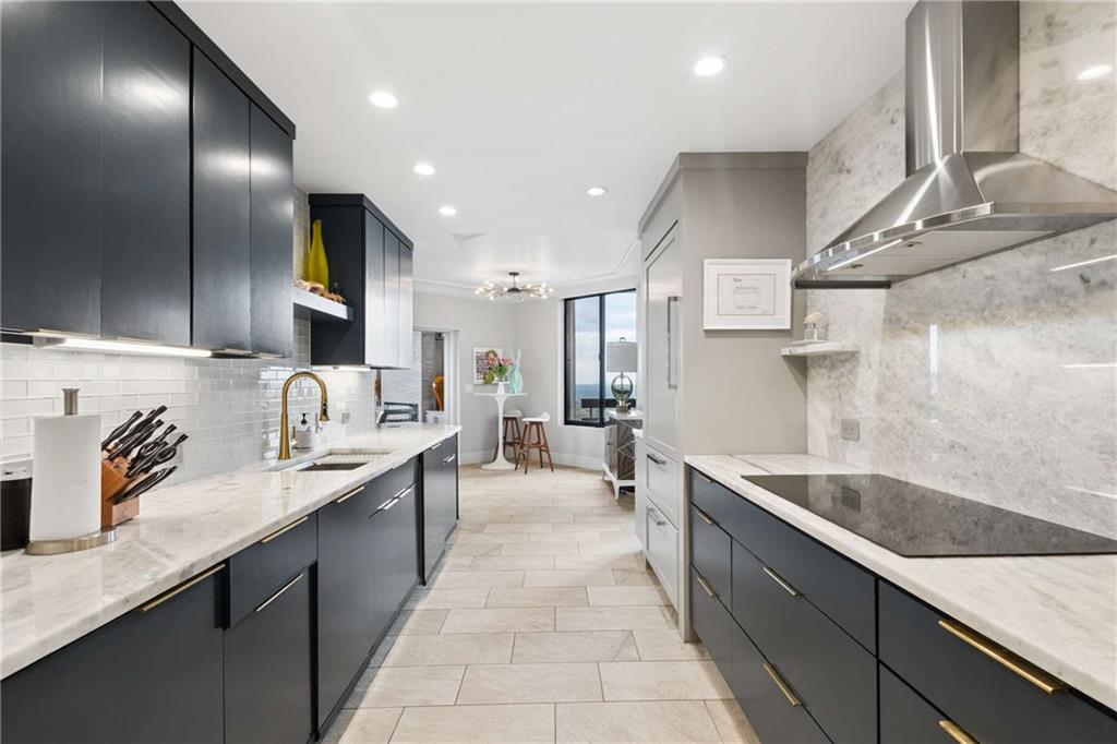 2660 Peachtree Road Northwest, Unit 34F Atlanta, GA 30305 - Photo 22 of 57 a large kitchen with stainless steel appliances a sink stove and cabinets