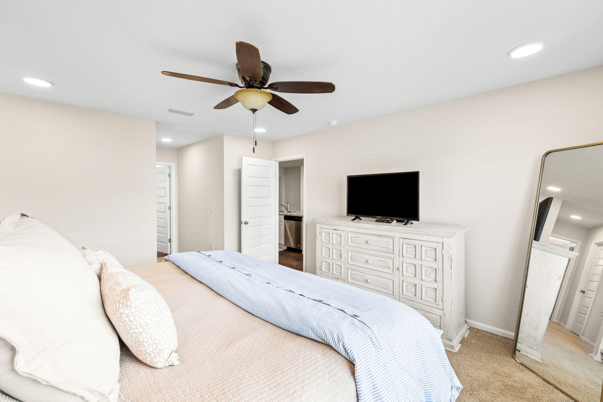 245 This Way Freeport, FL 32439 - Photo 18 of 46 a bedroom with a bed and a flat screen tv