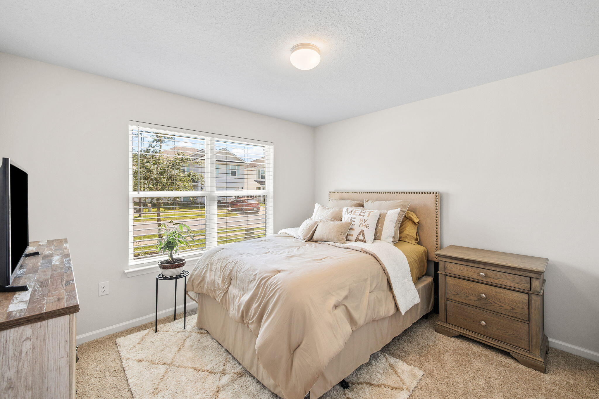 245 This Way Freeport, FL 32439 - Photo 23 of 46 a large bed sitting in a bedroom next to a window