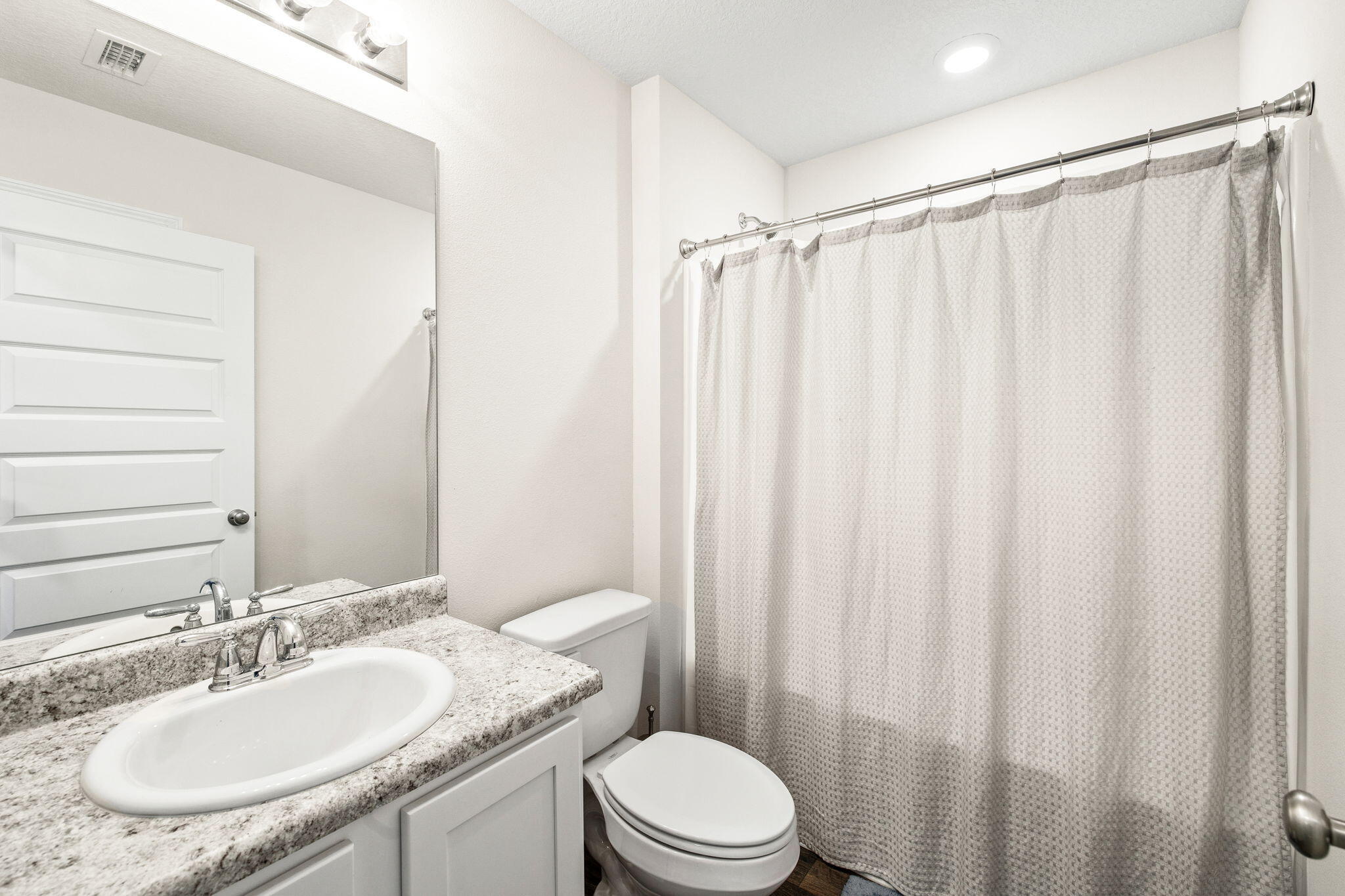 245 This Way Freeport, FL 32439 - Photo 25 of 46 a bathroom with a granite countertop sink toilet and a mirror