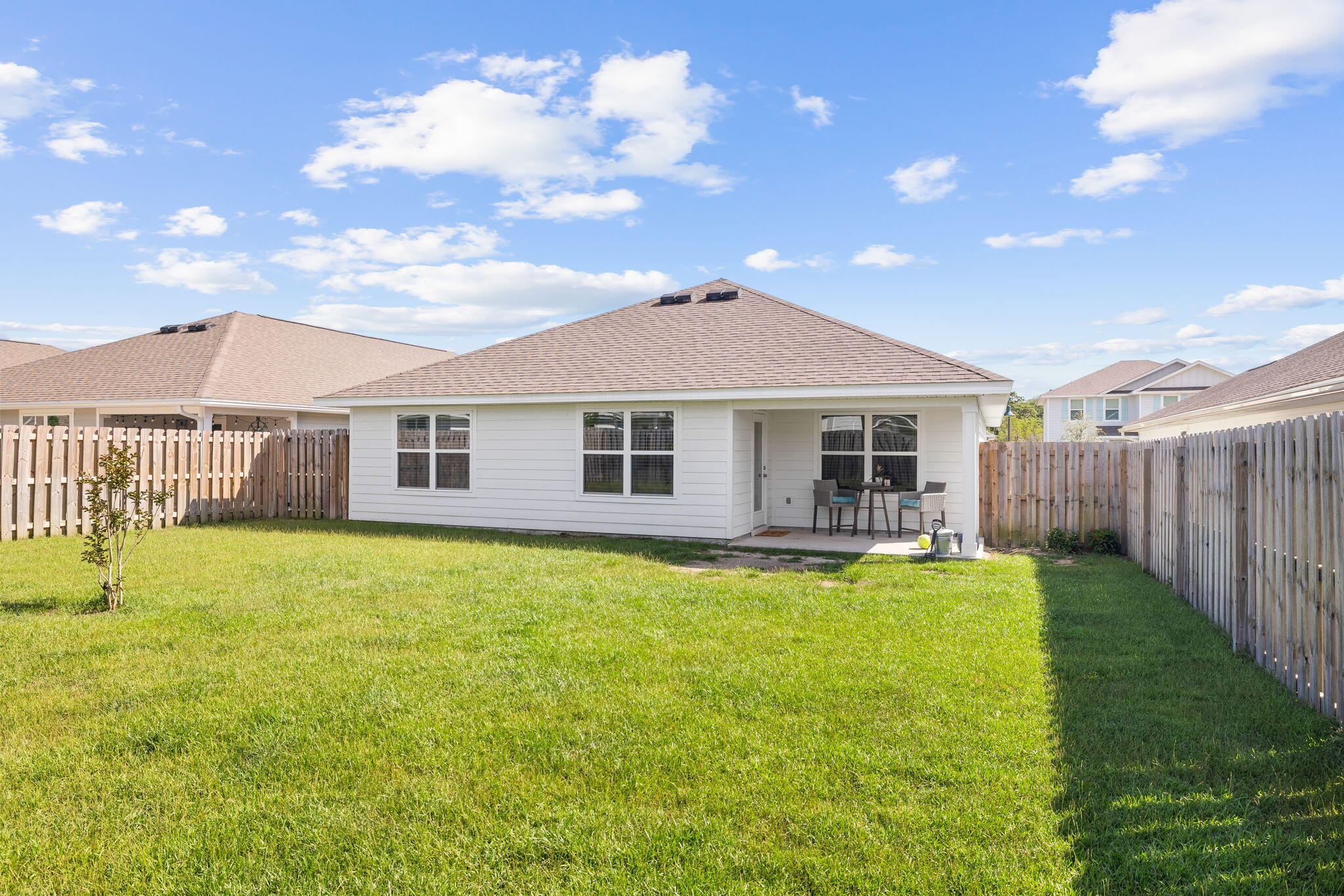 245 This Way Freeport, FL 32439 - Photo 27 of 46 a front view of a house with swimming pool having outdoor seating