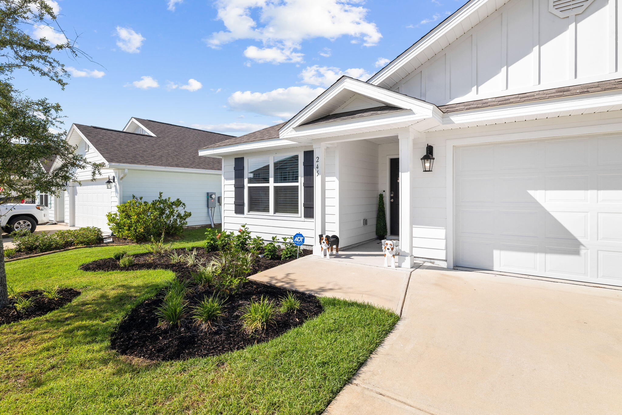 245 This Way Freeport, FL 32439 - Photo 3 of 46 a front view of a house with garden