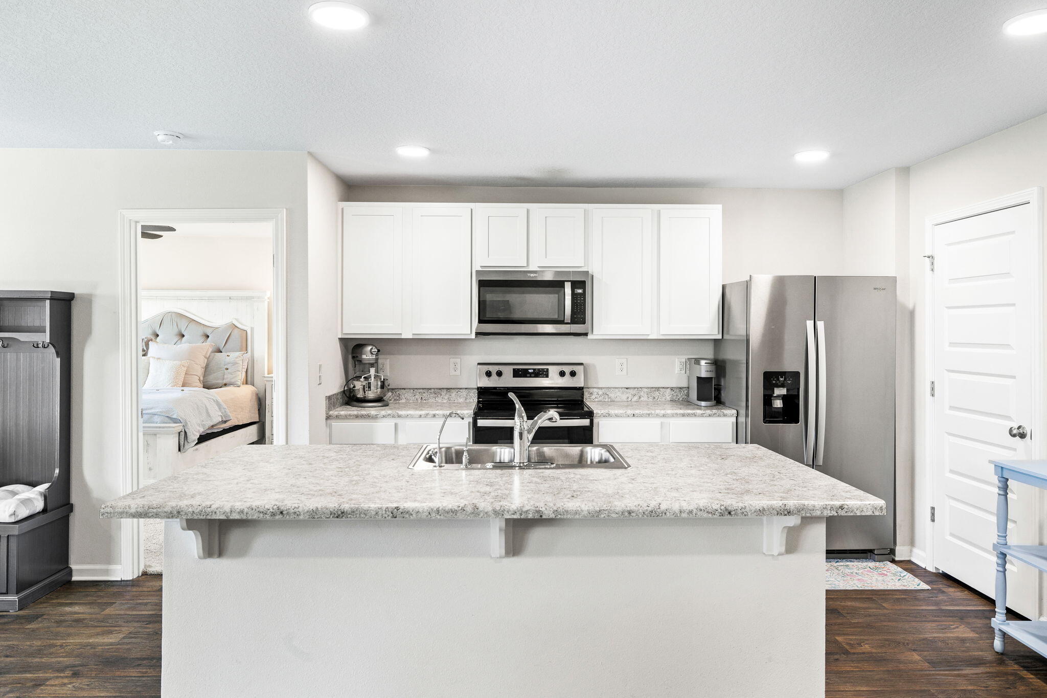 245 This Way Freeport, FL 32439 - Photo 5 of 46 a kitchen with a refrigerator a microwave a sink and cabinets