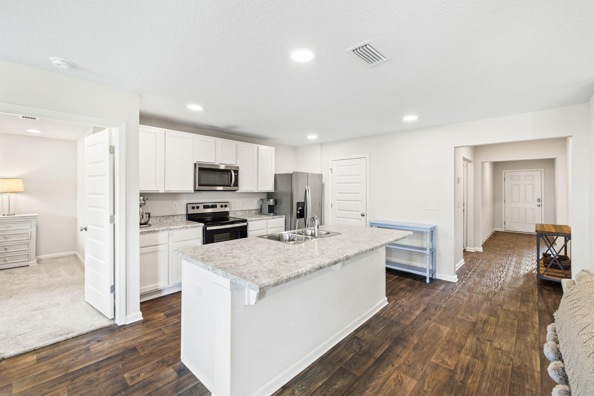 245 This Way Freeport, FL 32439 - Photo 6 of 46 a kitchen with sink a microwave and refrigerator