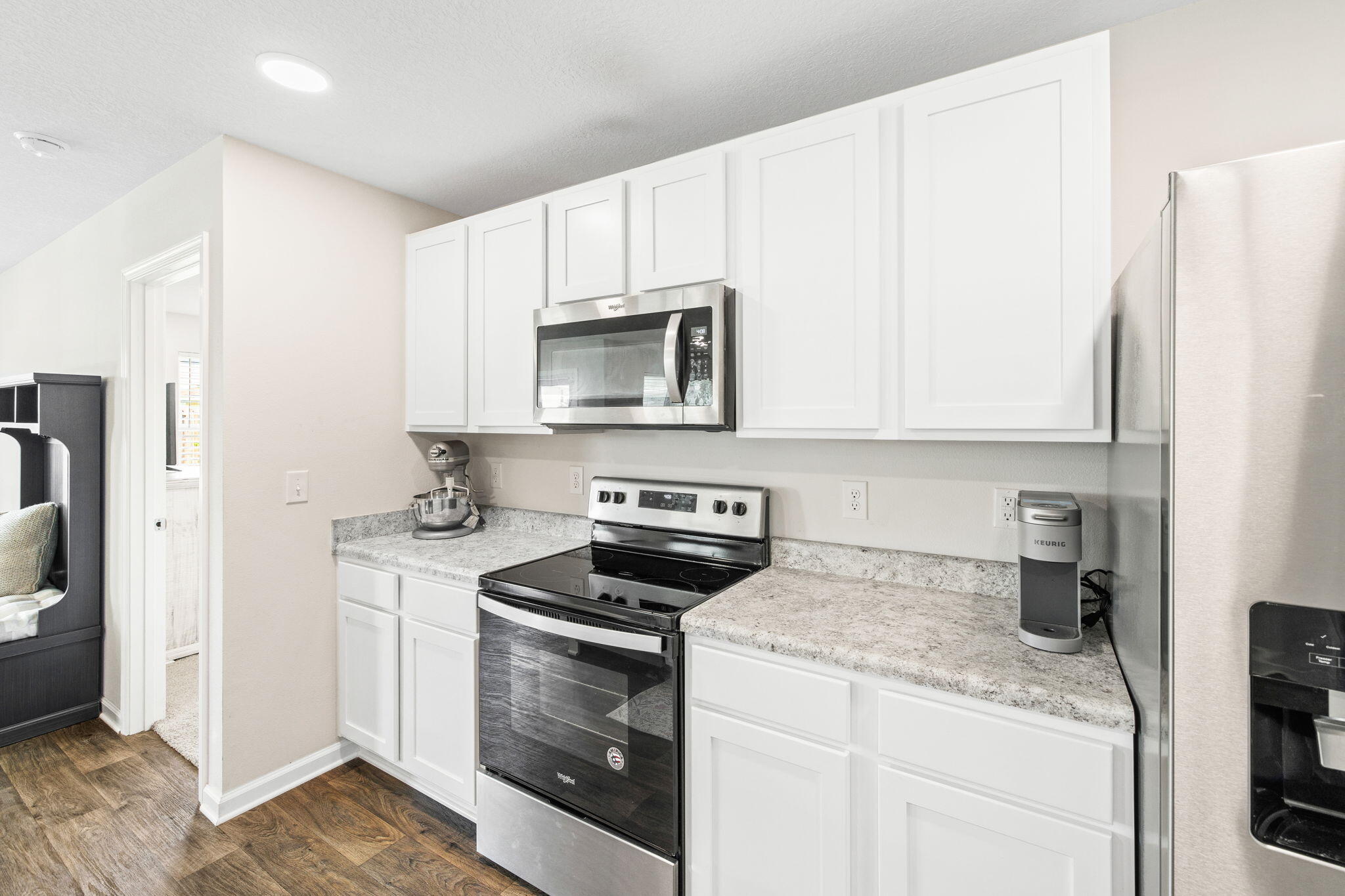 245 This Way Freeport, FL 32439 - Photo 7 of 46 a kitchen with stainless steel appliances granite countertop a refrigerator sink and stove