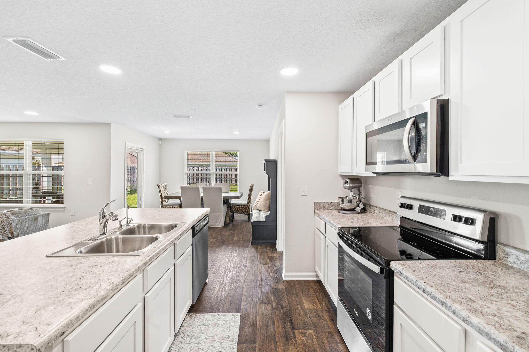 245 This Way Freeport, FL 32439 - Photo 8 of 46 a kitchen that has a sink a stove and wooden floor