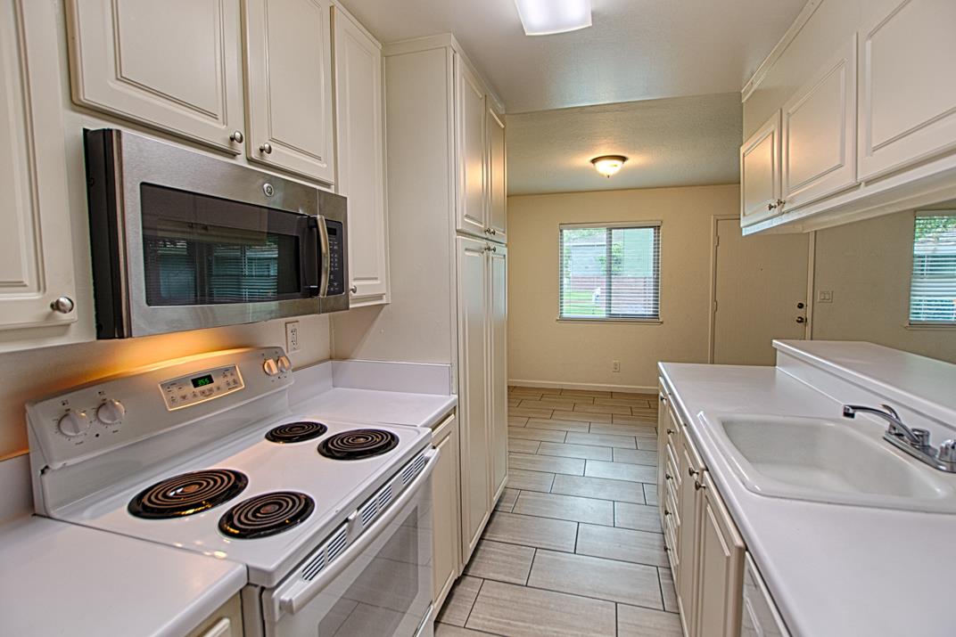 4380 Diamond Street, Unit 3 Capitola, CA 95010 - Photo 4 of 22 a kitchen with a sink a stove and microwave