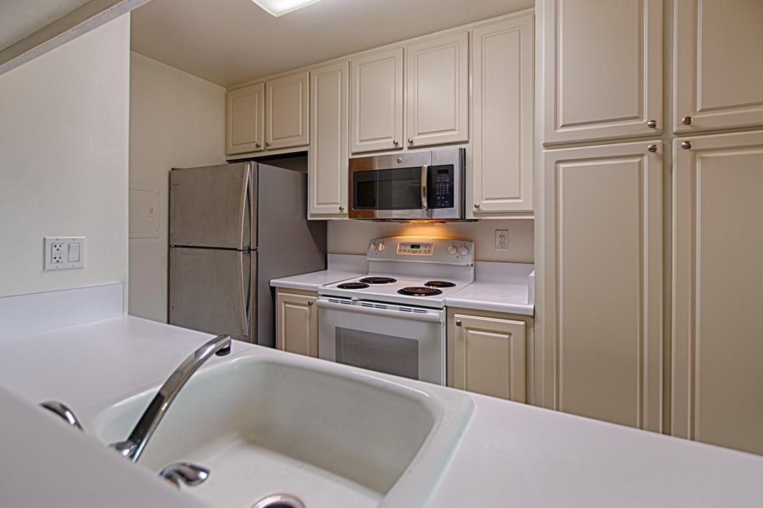 4380 Diamond Street, Unit 3 Capitola, CA 95010 - Photo 5 of 22 a kitchen with a refrigerator stove and microwave