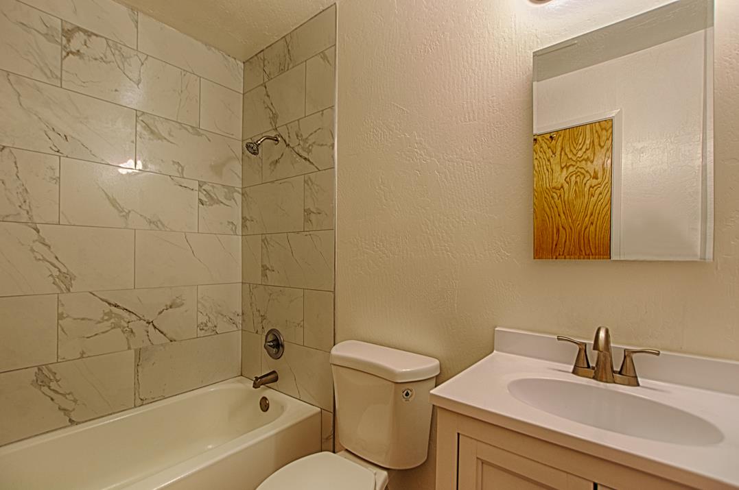 4380 Diamond Street, Unit 3 Capitola, CA 95010 - Photo 7 of 22 a bathroom with a sink mirror toilet and bathtub