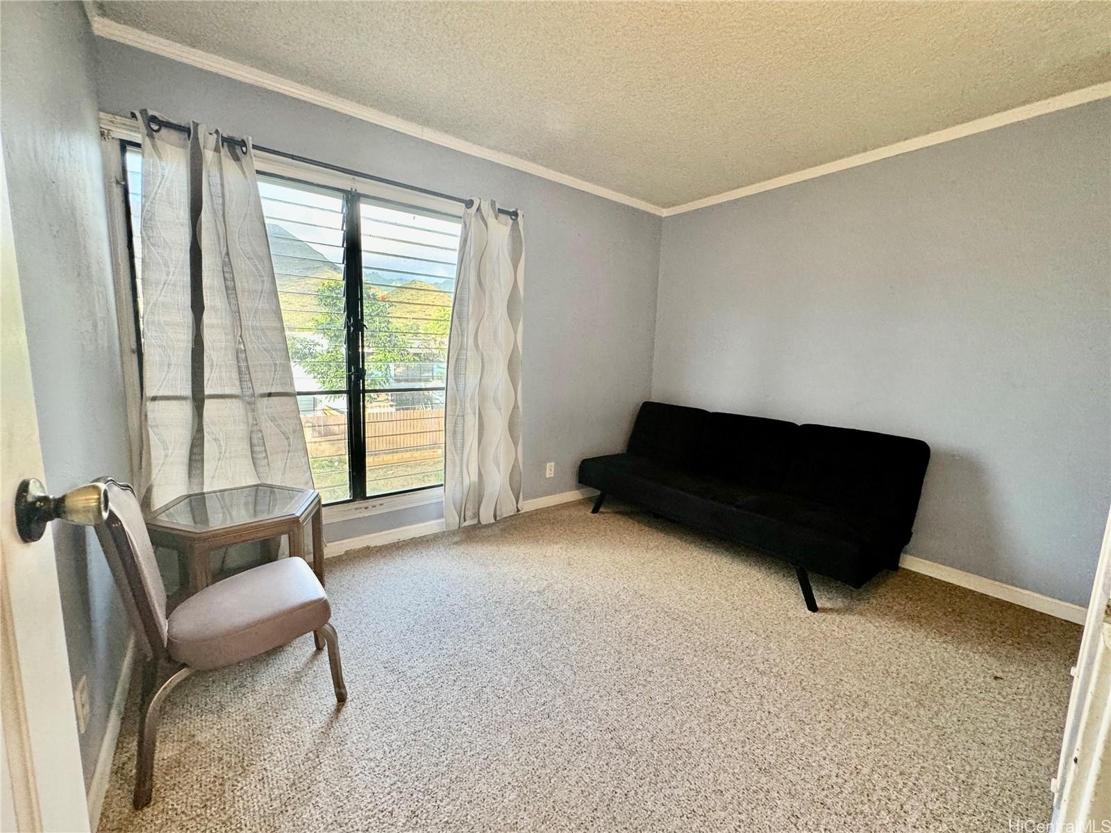 87-122 Helelua Street, Unit C201 Waianae, HI 96792 - Photo 12 of 19 a room with furniture and a window