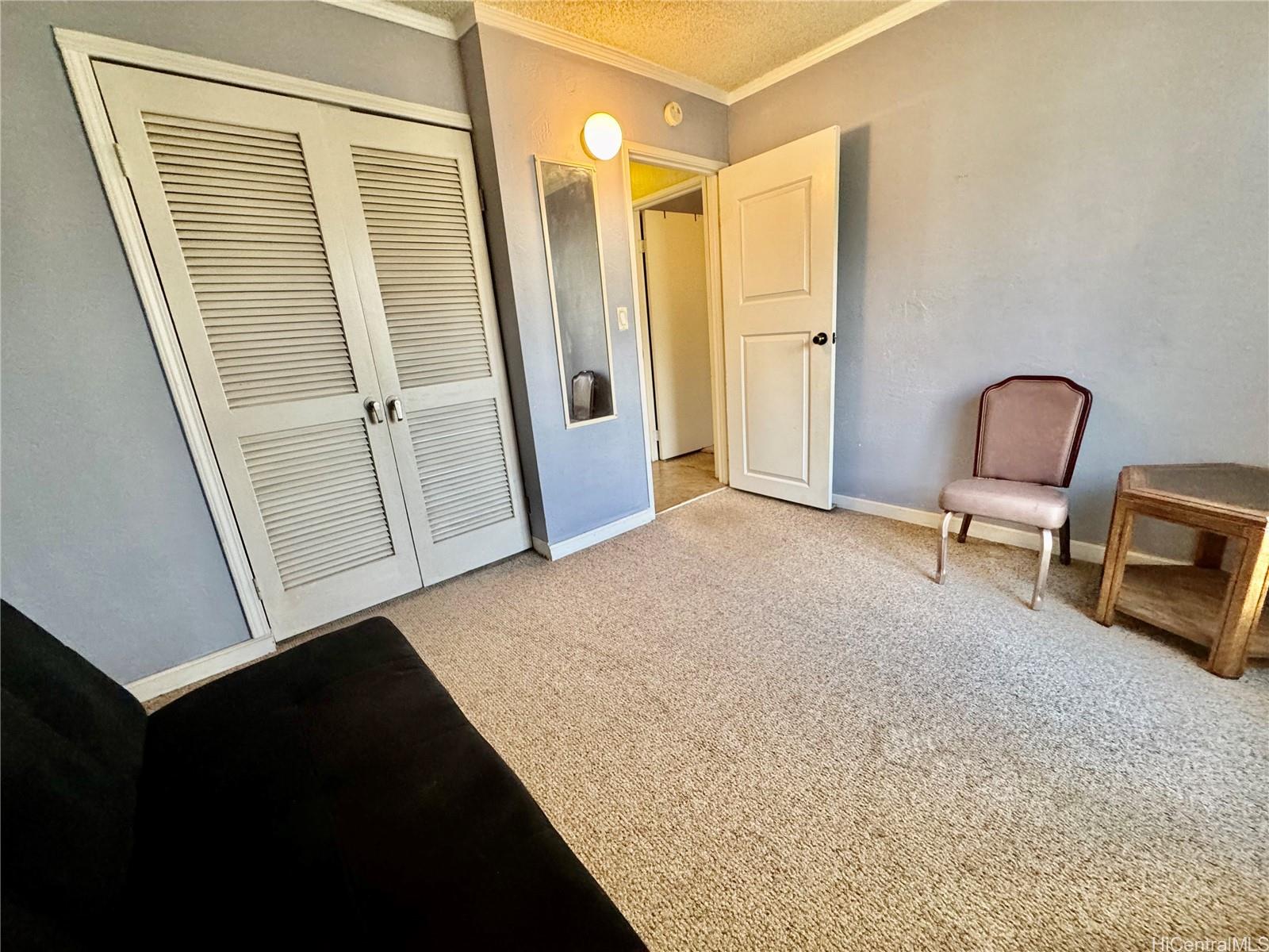 87-122 Helelua Street, Unit C201 Waianae, HI 96792 - Photo 13 of 19 a view of a hallway with entryway wooden floor and windows