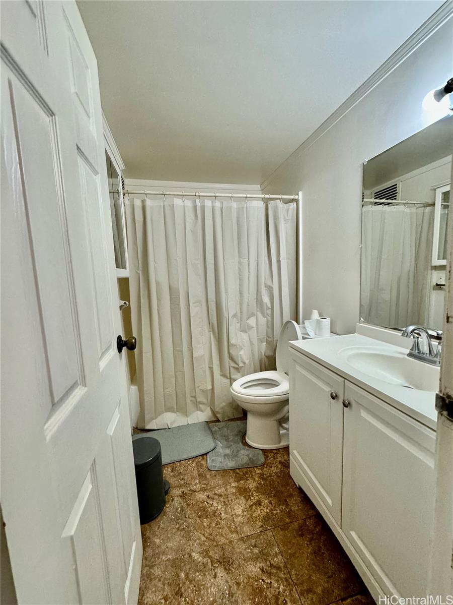87-122 Helelua Street, Unit C201 Waianae, HI 96792 - Photo 17 of 19 a bathroom with a sink toilet and shower