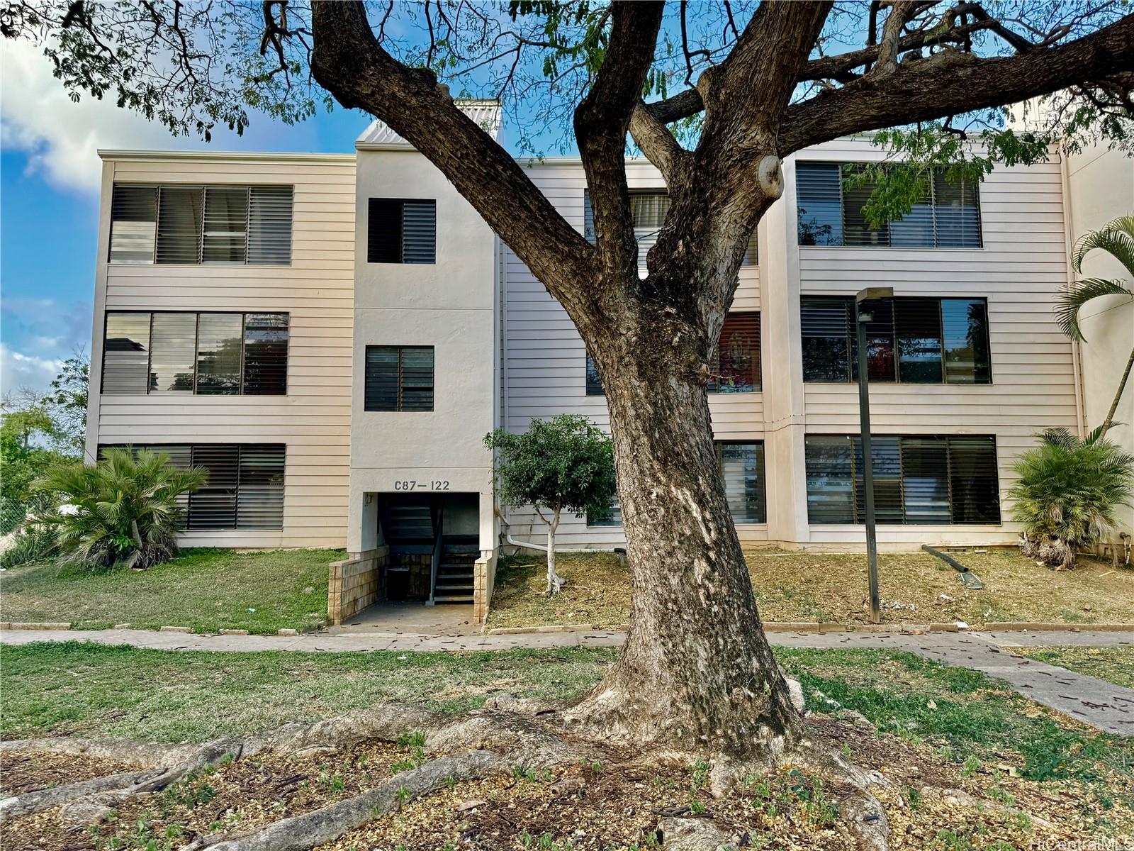 87-122 Helelua Street, Unit C201 Waianae, HI 96792 - Photo 18 of 19 a view of a yard in front of a house with a large tree
