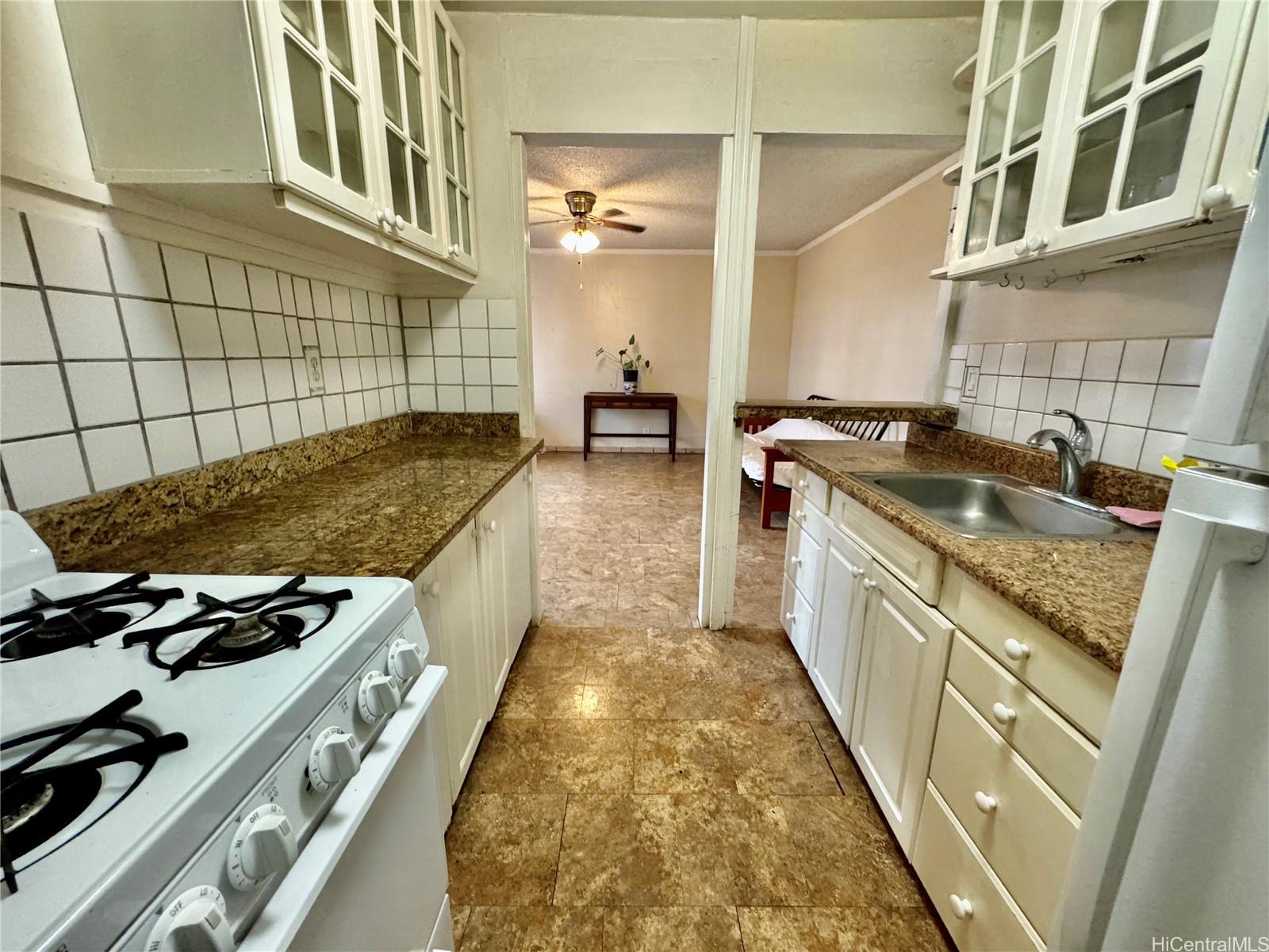 87-122 Helelua Street, Unit C201 Waianae, HI 96792 - Photo 8 of 19 a kitchen with a stove and a sink