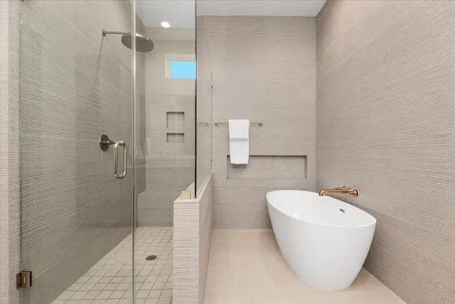 a bathroom with a bathtub and shower