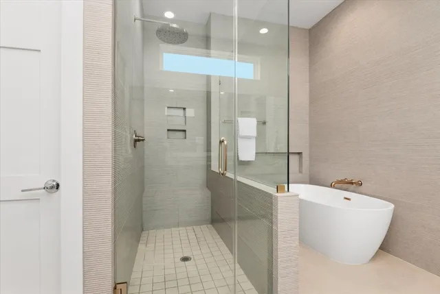 a bathroom with a bathtub and shower
