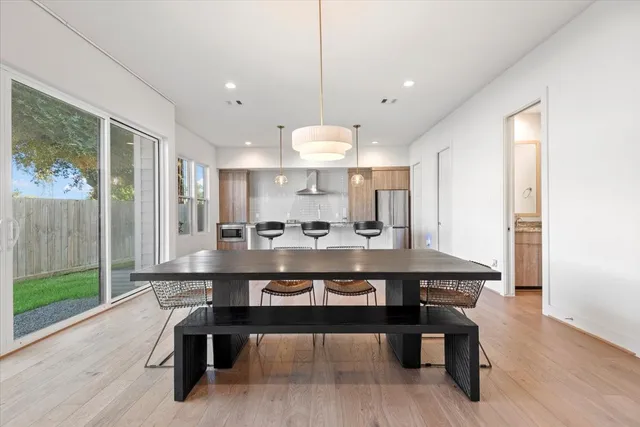 a large kitchen with a table and chairs