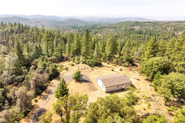 a view of a yard with wooden fence