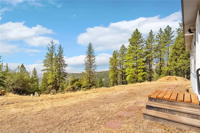 a view of a house with a yard covered in snow