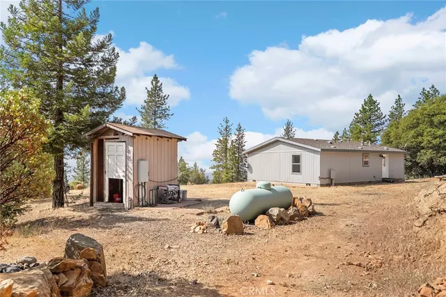 a kitchen with stainless steel appliances granite countertop a refrigerator a sink dishwasher a stove and a refrigerator with wooden floor