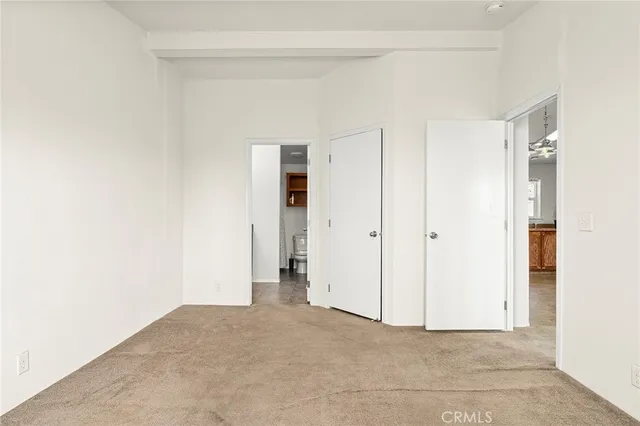 a bathroom with a granite countertop sink a toilet and a mirror