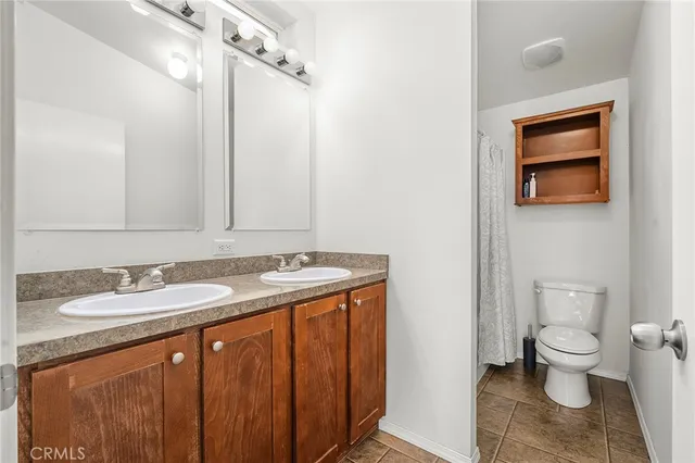 a bathroom with a shower curtain and mirror